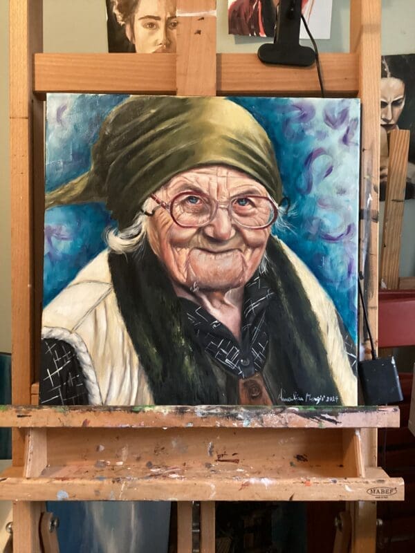 Oil painting of an elderly woman titled 'Wisdom,' capturing her serene and wise expression, with detailed wrinkles and marks reflecting a lifetime of experiences. Irish Artmart