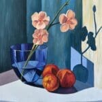 A branch of peach blossoms in a glass goblet with peach